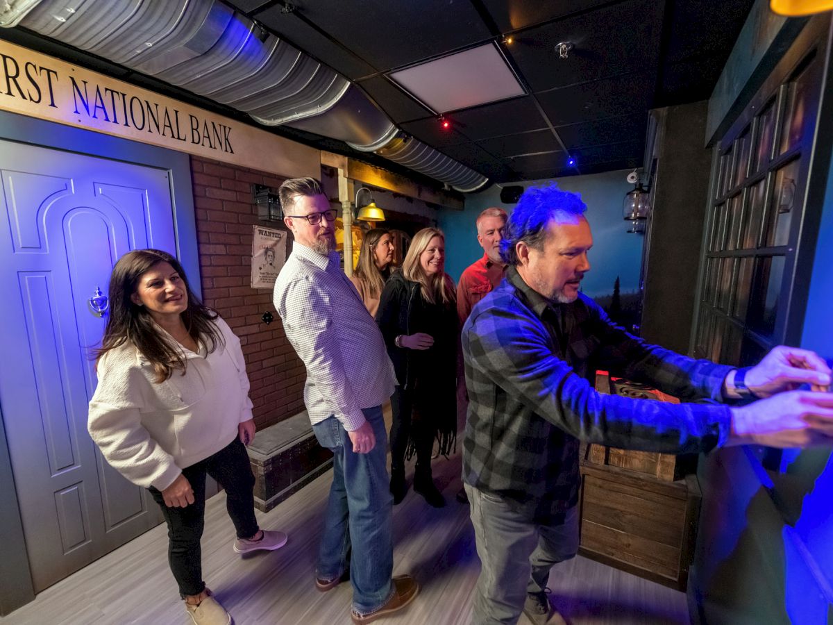 A group of people appear to be participating in an escape room activity, standing near a door labeled 