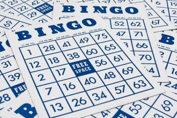 The image shows multiple Bingo cards, each with a grid of numbers and a free space in the center, arranged in a scattered manner.